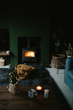 A cozy living room with a warm glow from a gas stove.