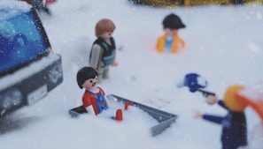 Playmobil® figures and playsets arranged in a lively city scene with children playing.