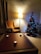 A cozy living room with festive decorations and twinkling lights.