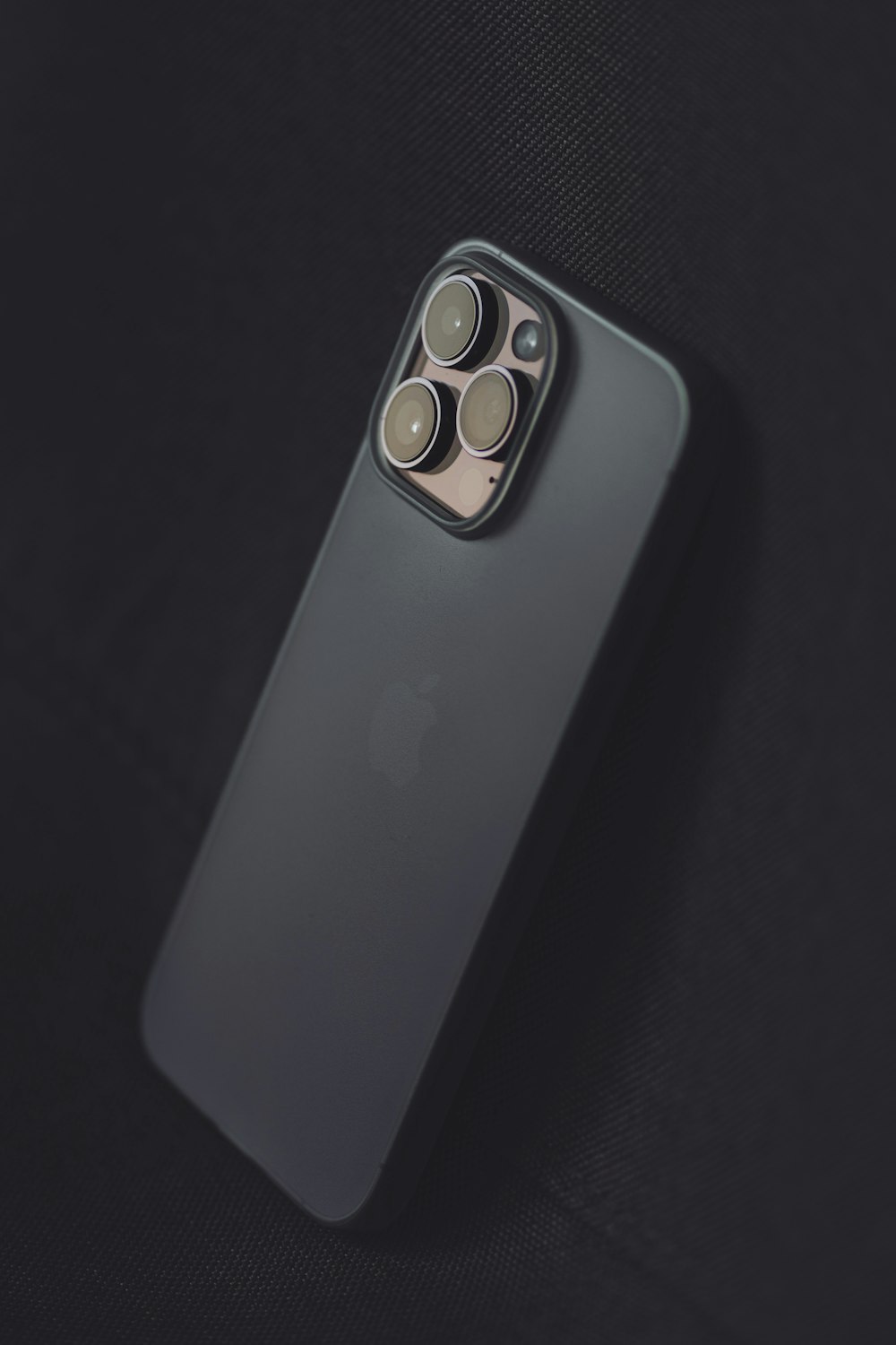 La parte posterior de un iPhone 11 Pro con una cámara conectada