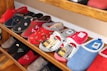 Various styles of cotton slippers displayed neatly on shelves.