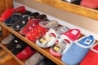 Various styles of cotton slippers displayed neatly on shelves.