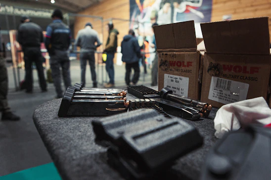 A diverse group of students attentively learning firearms safety in a bright, modern training room.