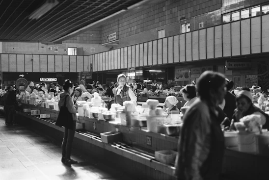A bustling Mercado Henrique Araujo store interior with diverse customers shopping and staff assisting warmly.