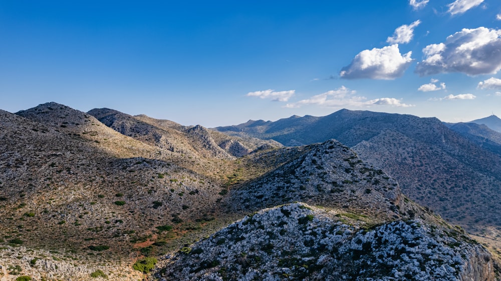 a view of a mountain range from the top of a hill