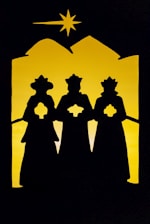 a silhouette of three people standing in front of a star
