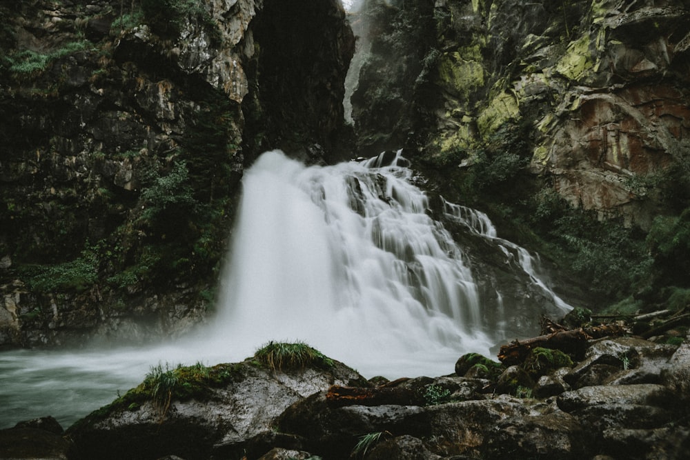 a large waterfall with water cascading down it's sides