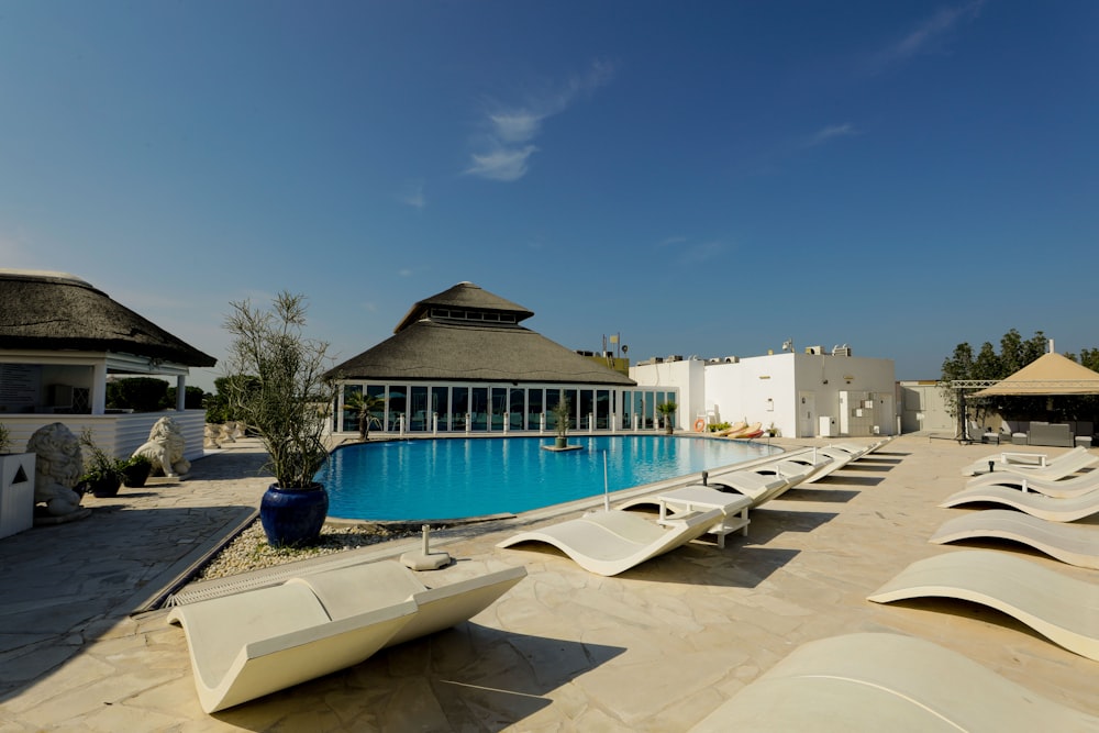 a large swimming pool surrounded by lounge chairs