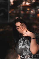 a woman sitting on a couch with her eyes closed