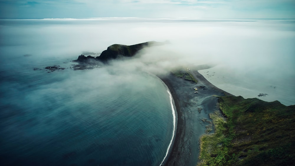 a large body of water surrounded by fog