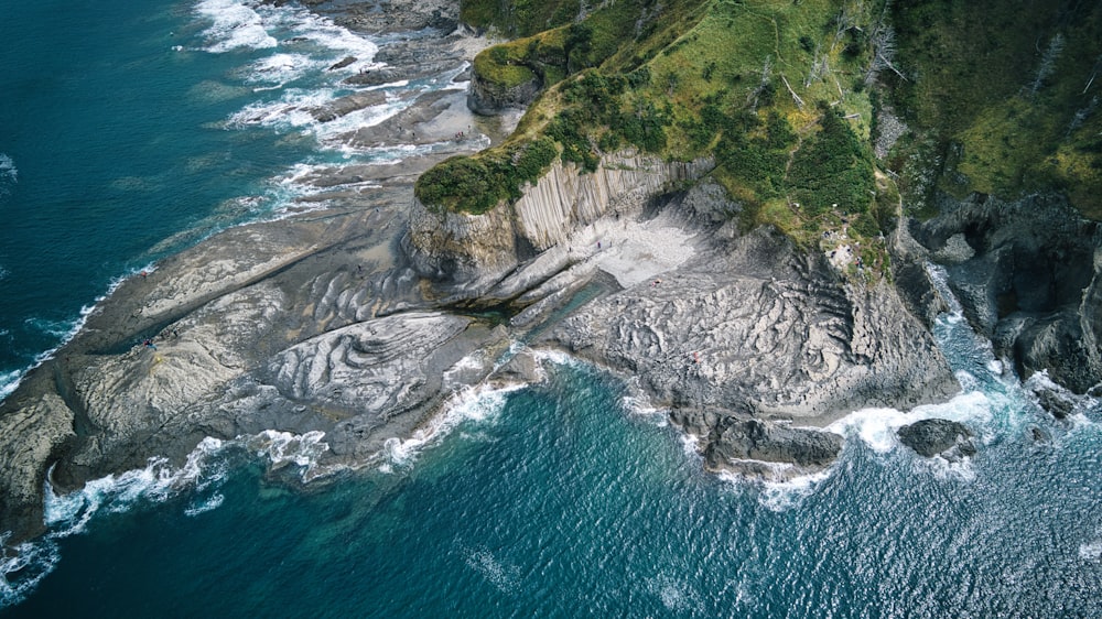 an aerial view of a rocky coastline and ocean