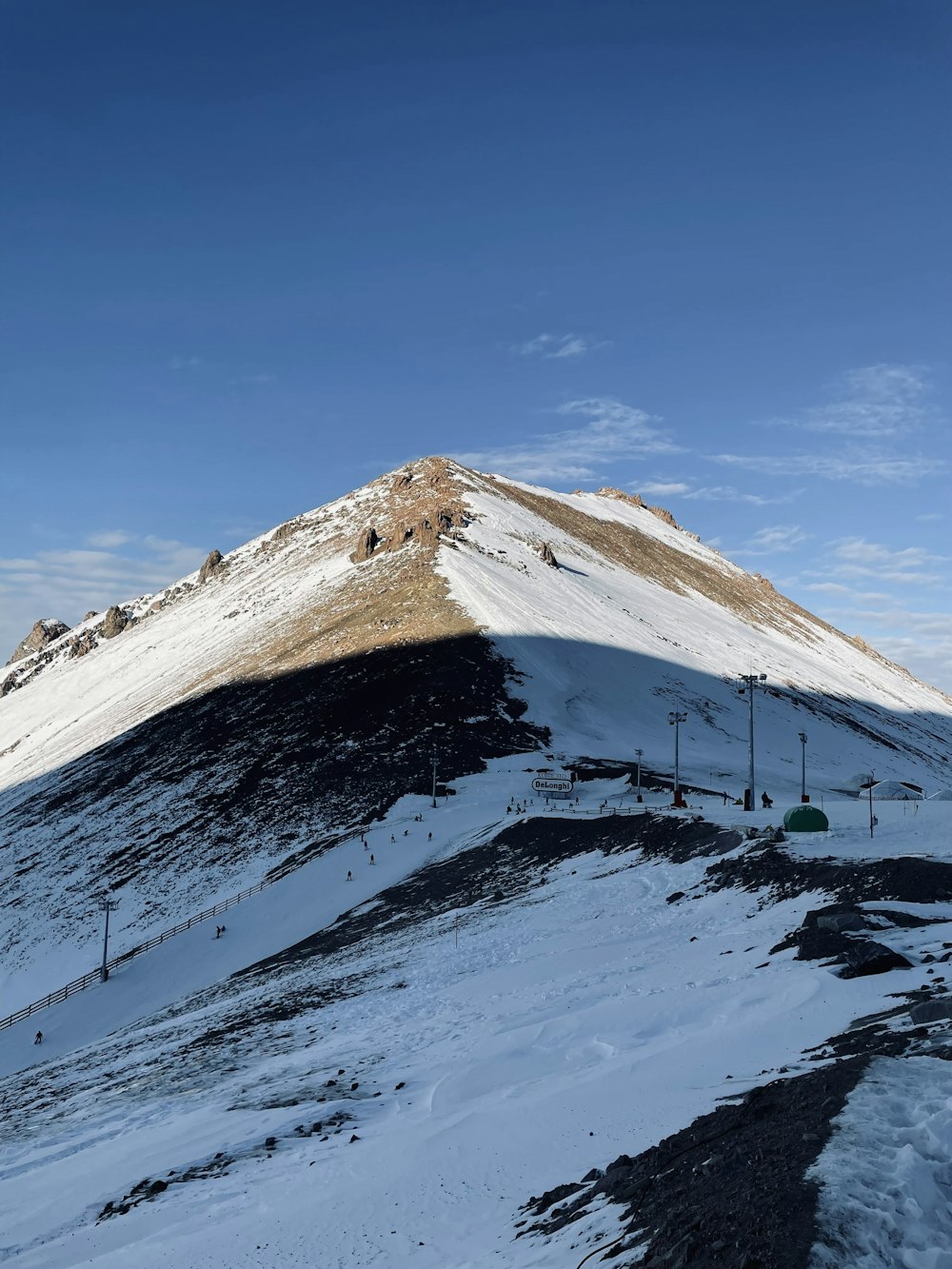 a snow covered mountain under a blue sky