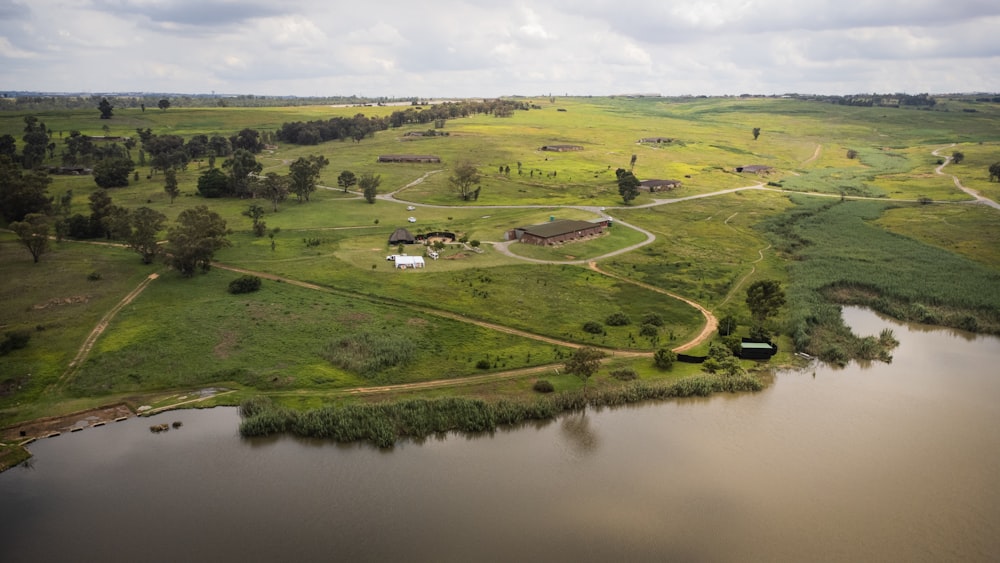 an aerial view of a farm and a lake