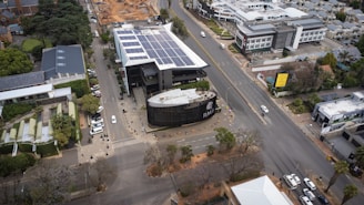 an aerial view of a city with a solar panel on the roof