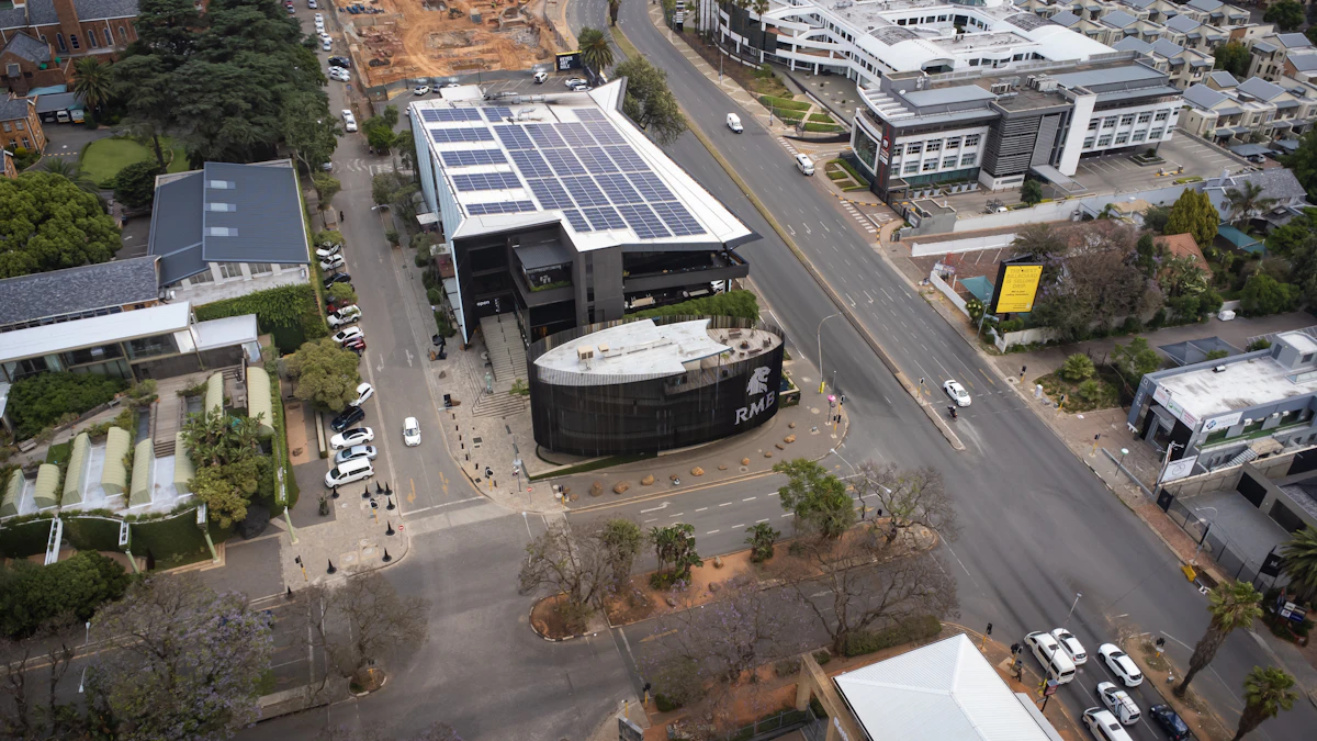 An aerial view of a small commercial building with solar panels installed on the roof.