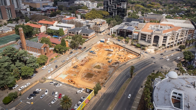 Aerial view of a commercial development site with visible roadworks and earthmoving