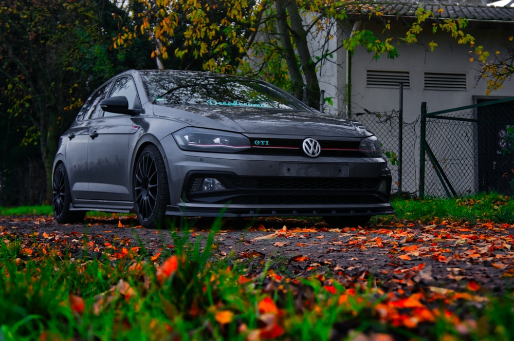 a gray car parked in front of a house