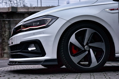 Volkswagen Golf GTI in motion, showcasing its sporty silhouette.