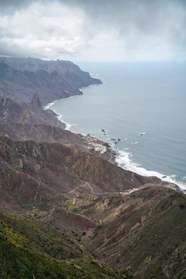 a scenic view of the ocean and mountains