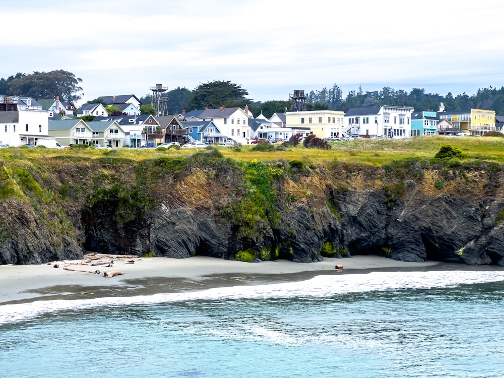 a view of a beach with houses in the background