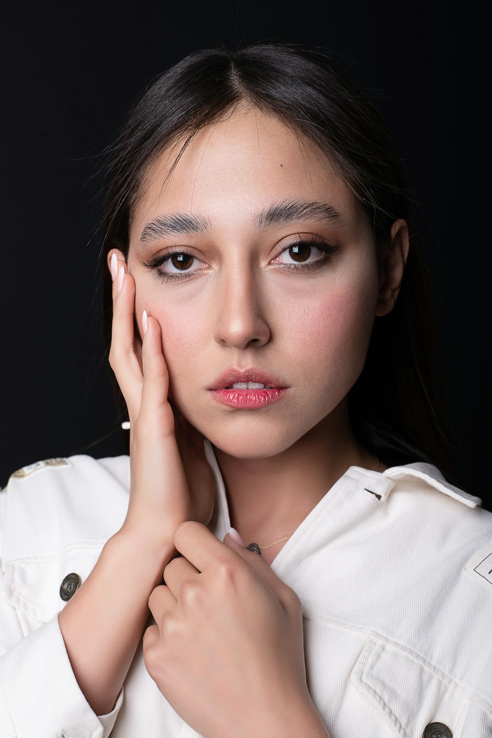 a woman in a white shirt is posing for a picture