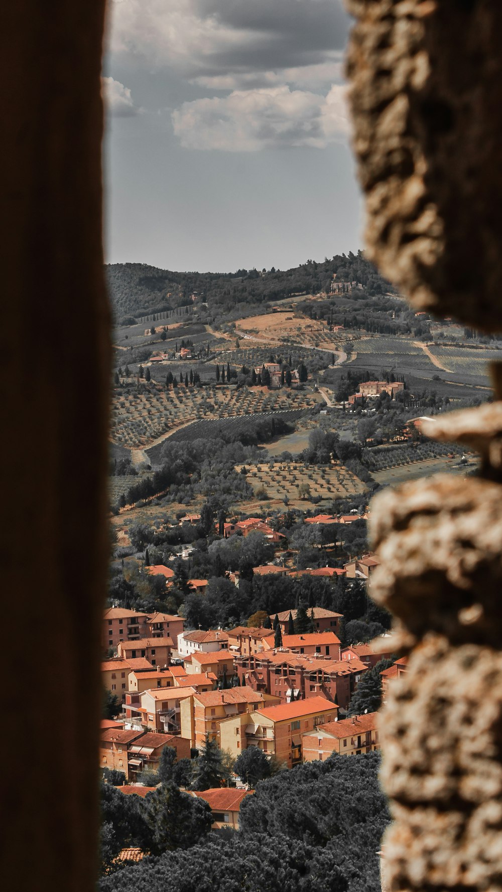 a view of a town from a window in a stone wall