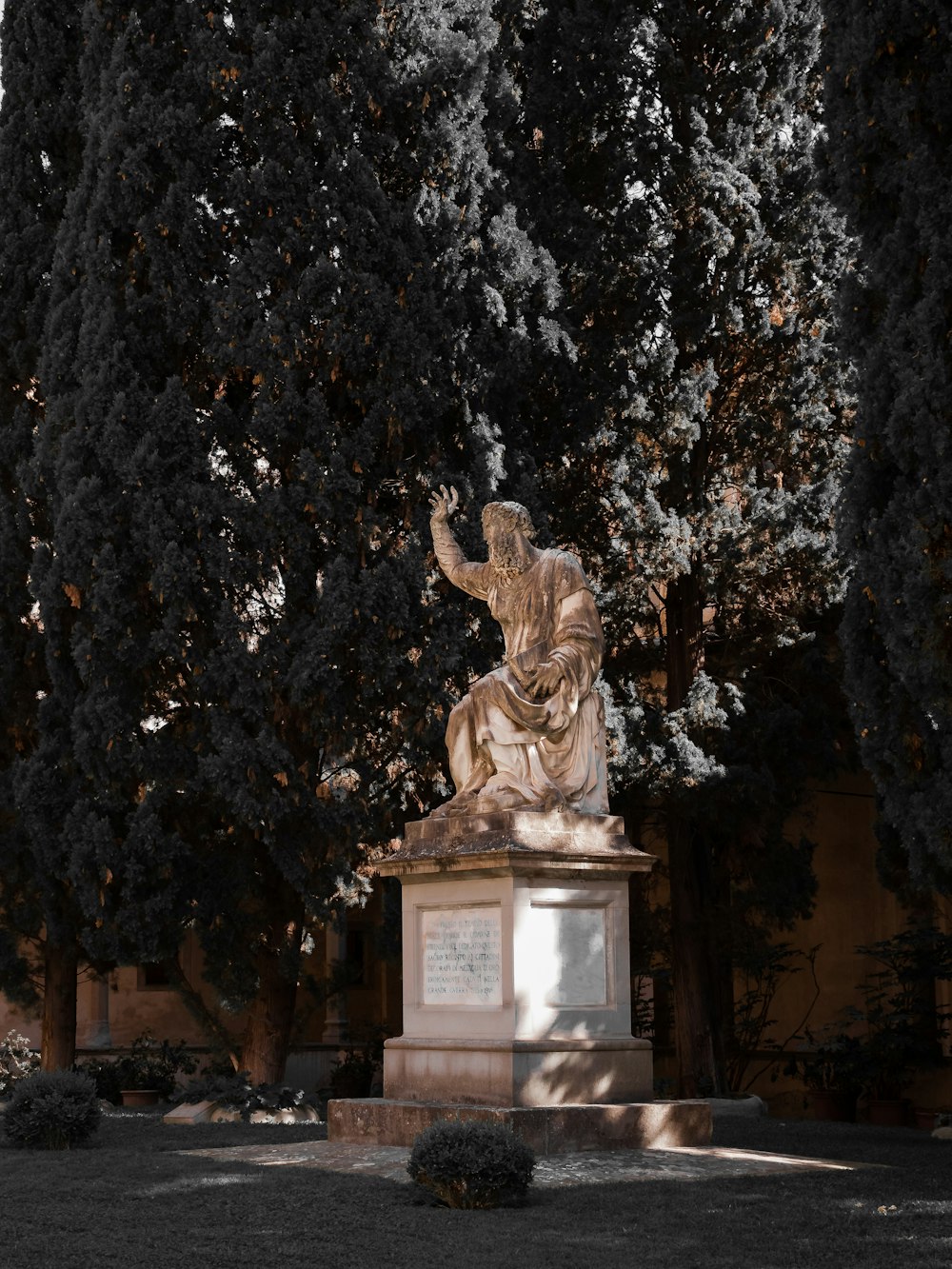 a statue of a man sitting on top of a bench