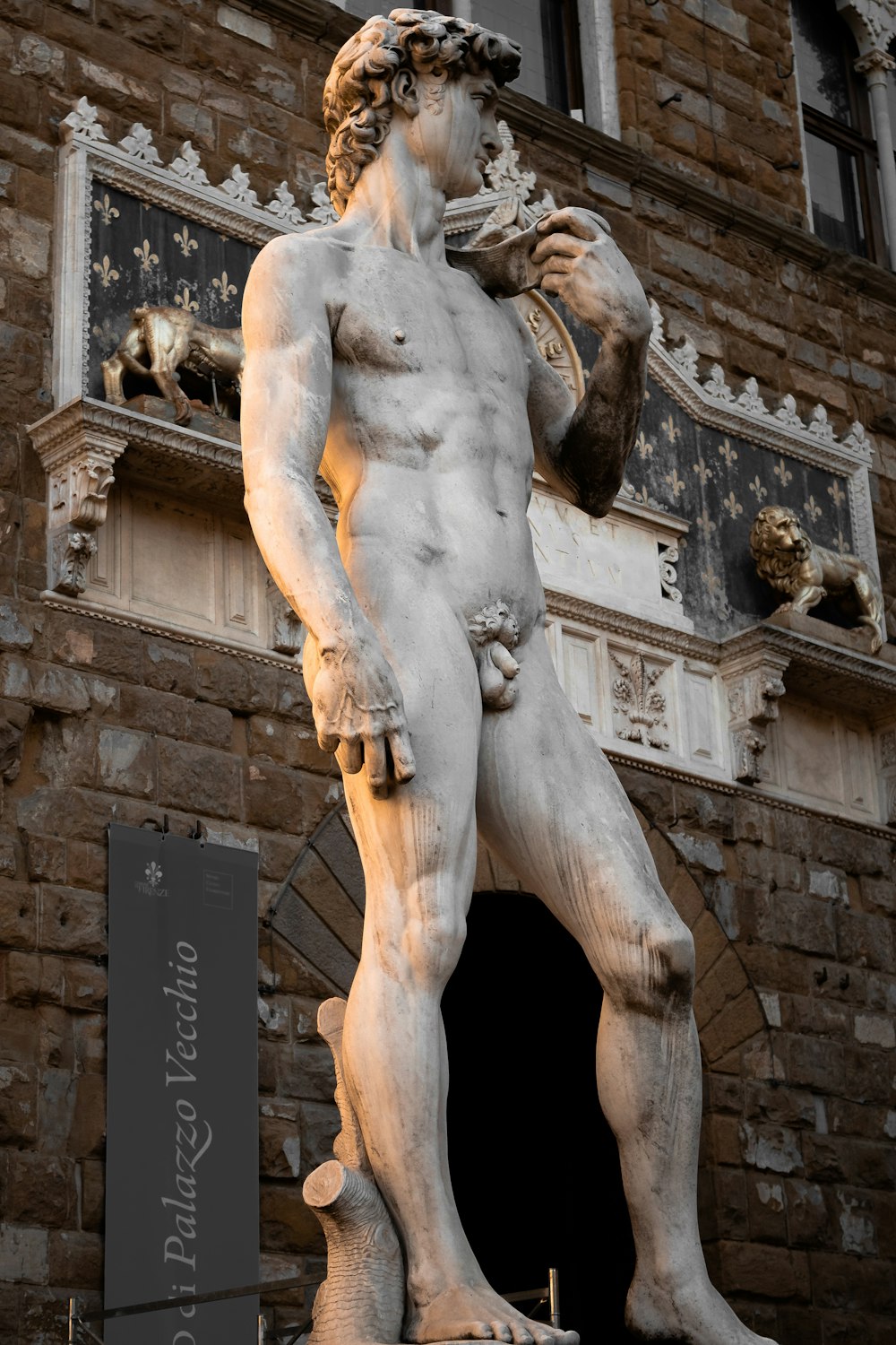 a statue of a man standing in front of a building