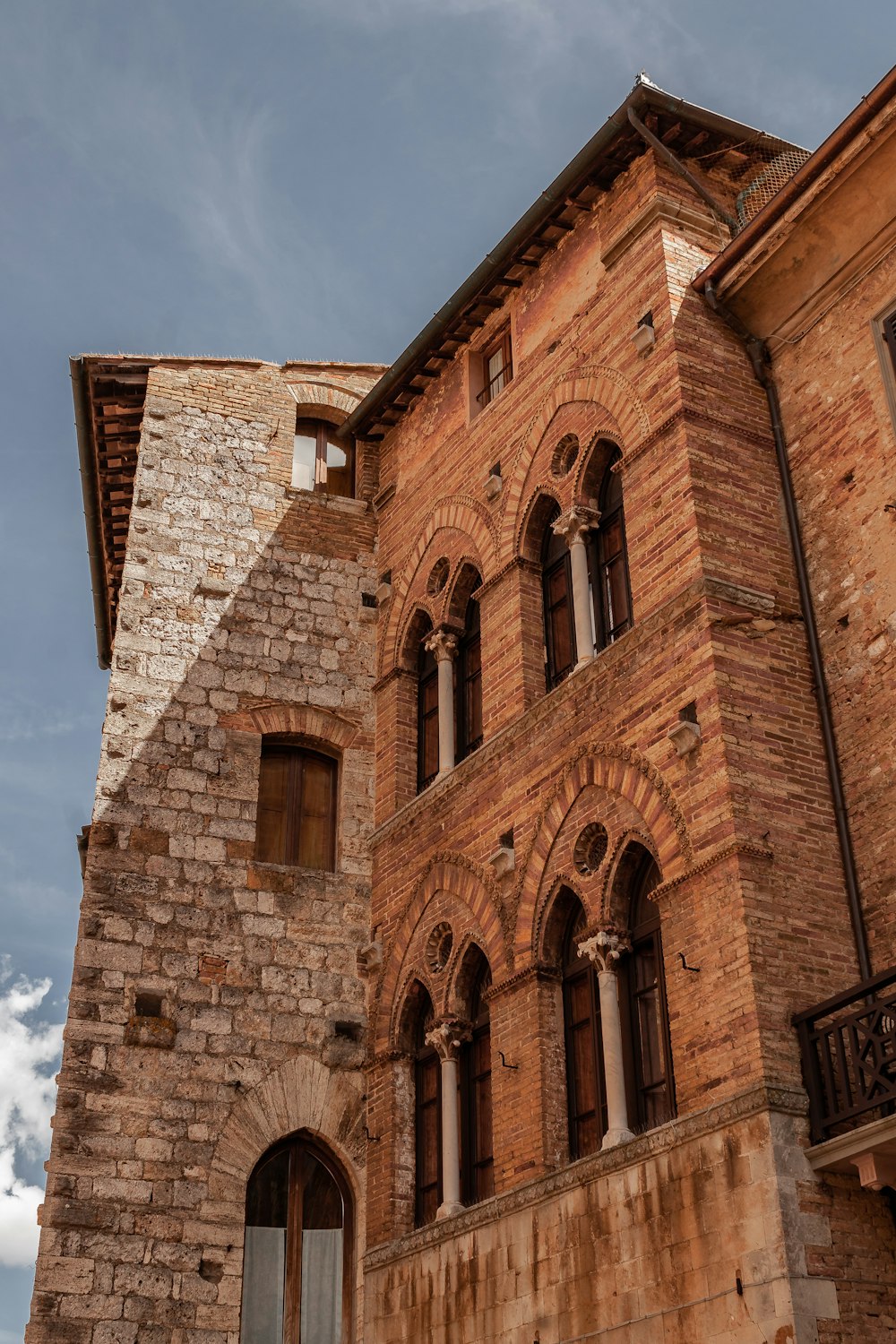 a tall brick building with a clock on it's side