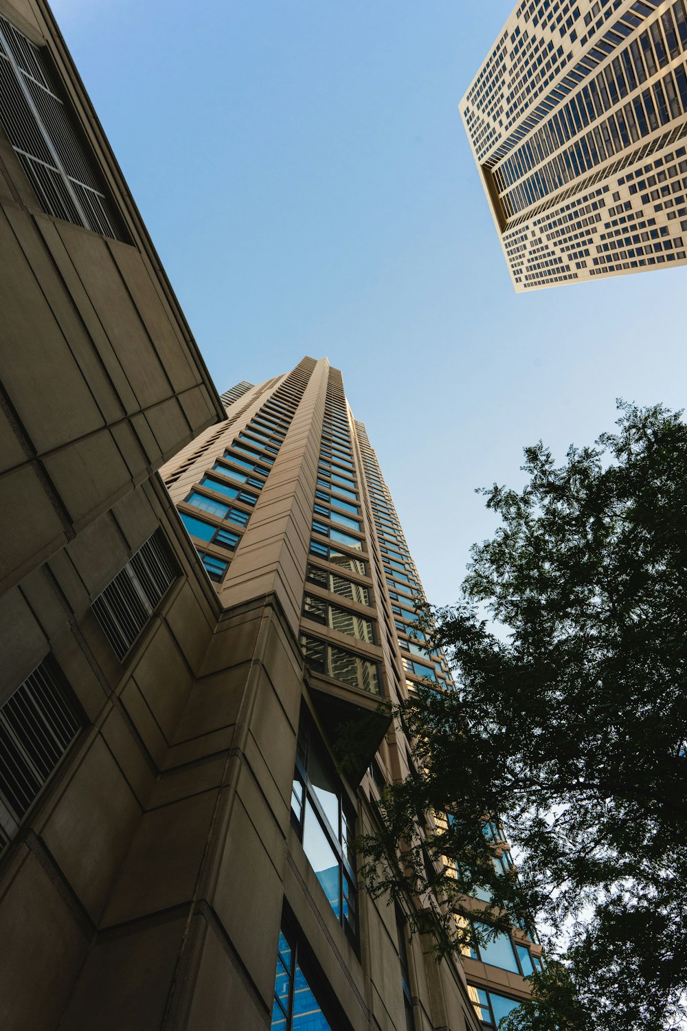 looking up at two tall buildings in a city