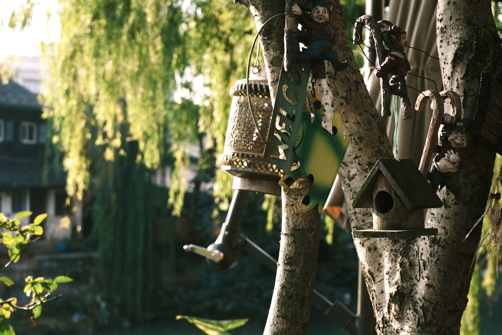 a bunch of bird houses hanging from a tree