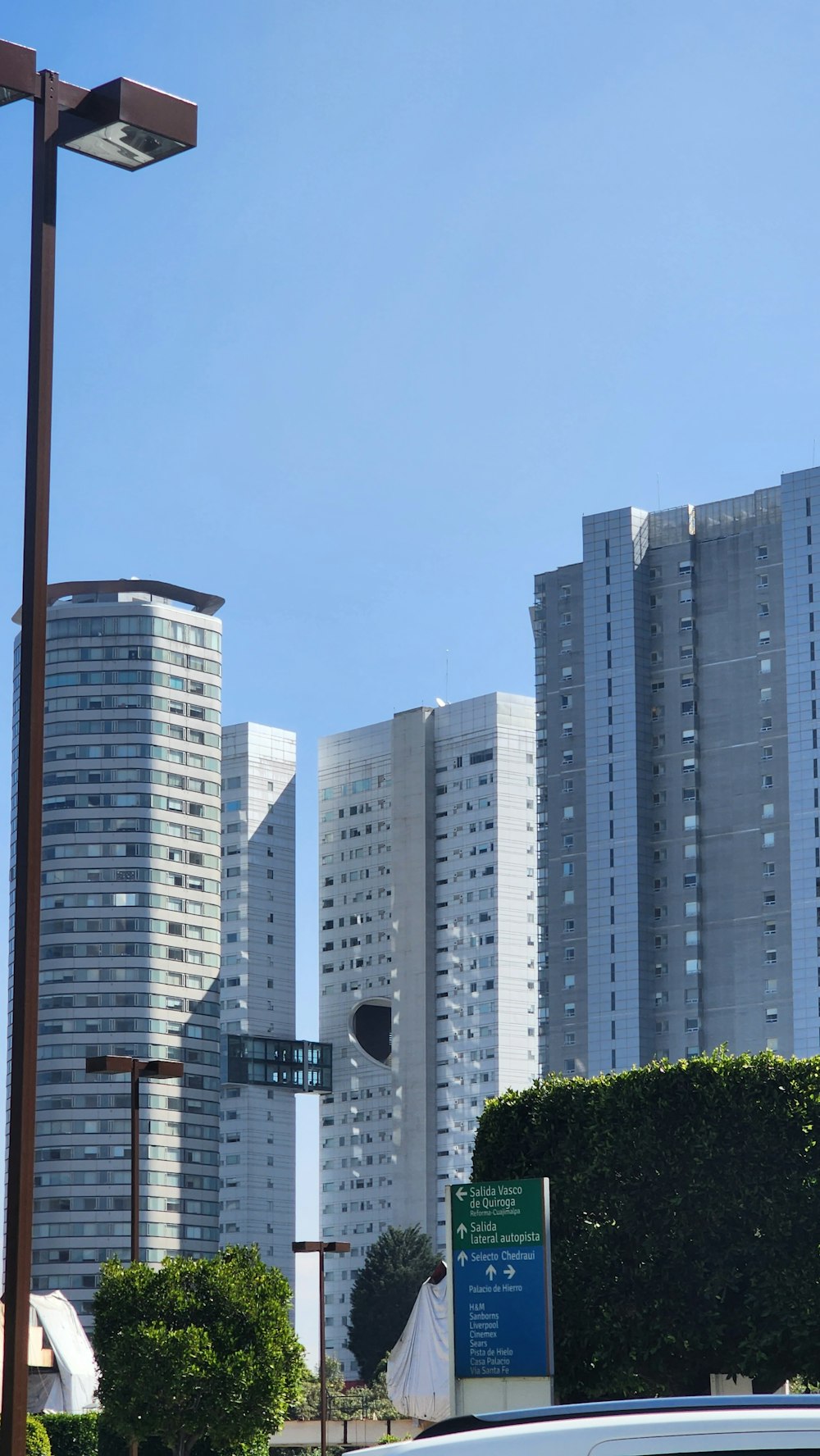 a city street with tall buildings in the background