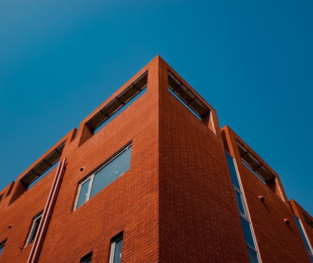 a red brick building with a blue sky in the background