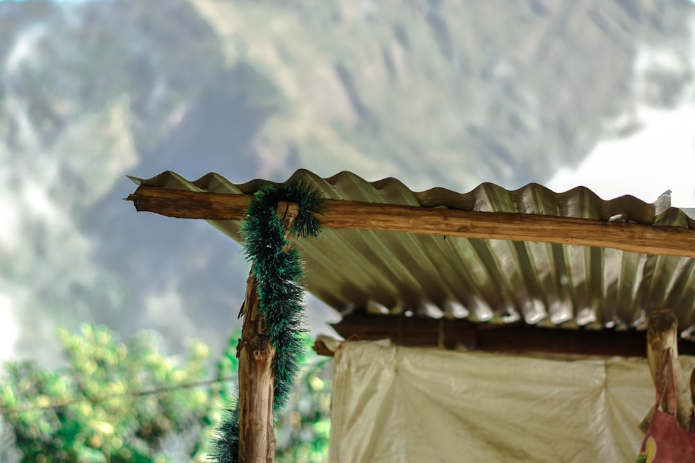 a close up of a wooden structure with a mountain in the background