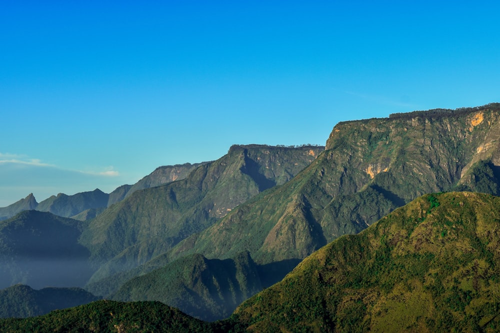 a view of a mountain range with a blue sky in the background