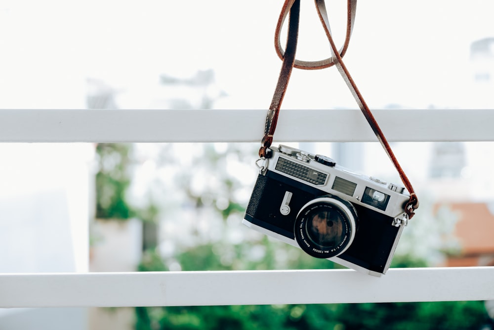 a camera is hanging on a rail outside