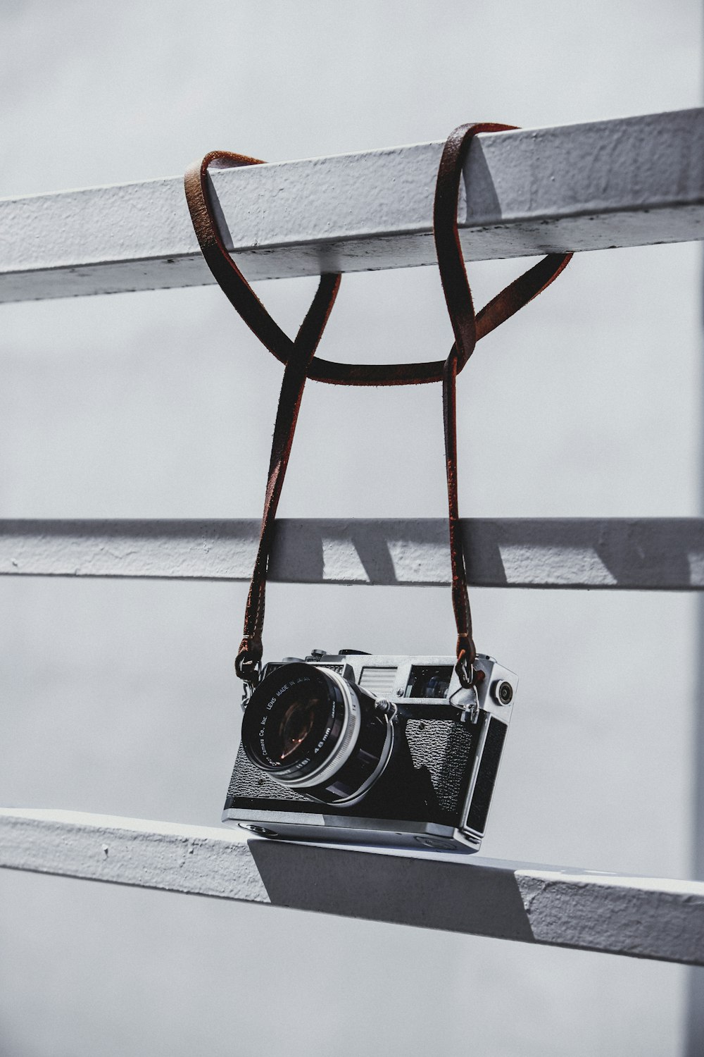 a camera is hanging on a metal rail