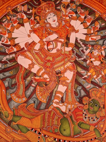 A detailed traditional mural painting depicting a highly adorned deity with multiple arms, each holding different objects. The deity's posture is dynamic, featuring intricate patterns on clothing and jewelry. A colorful and complex background illustrates mythological elements, enhancing the overall grandeur.