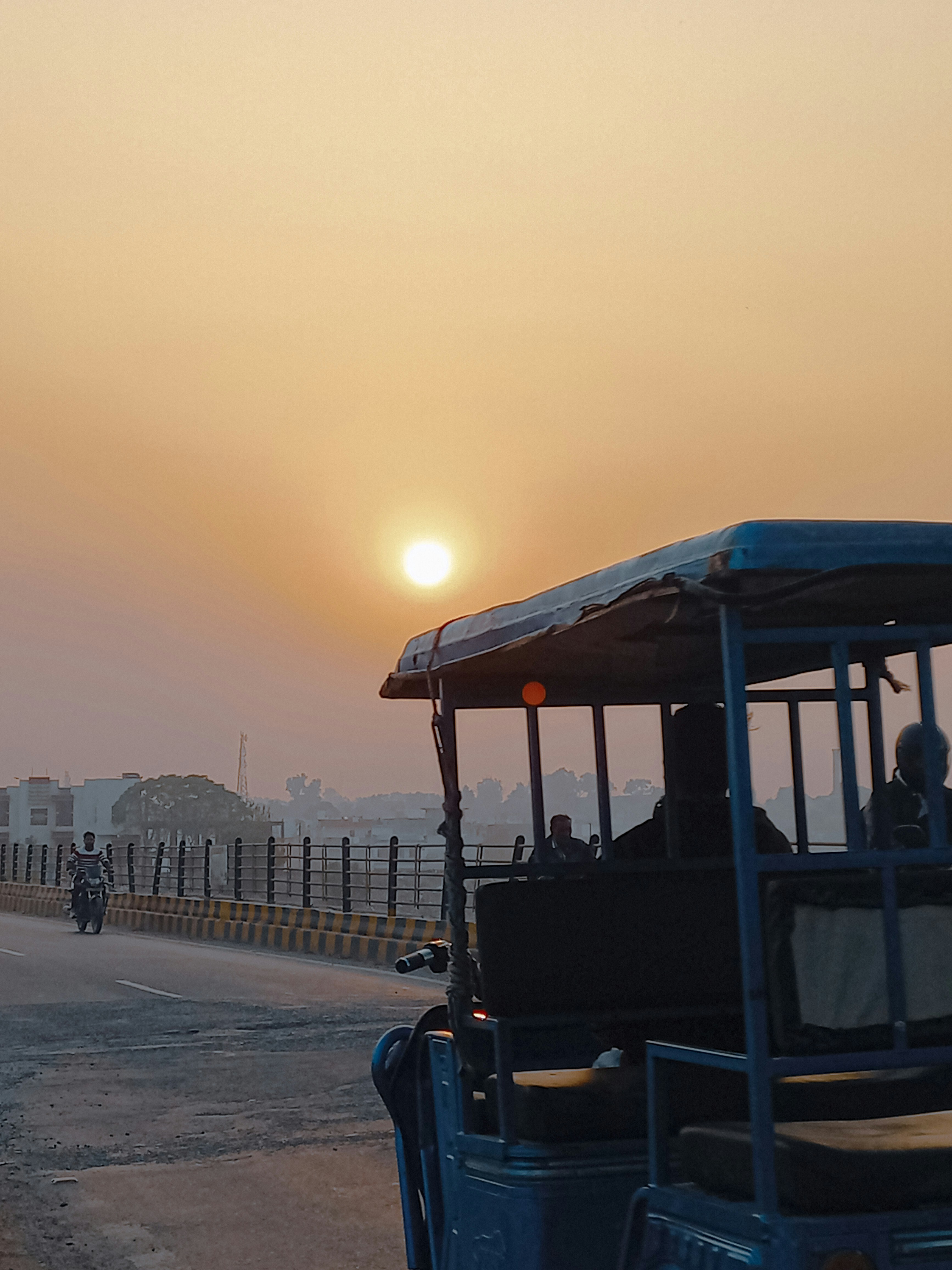 a group of people riding on the back of a blue bus