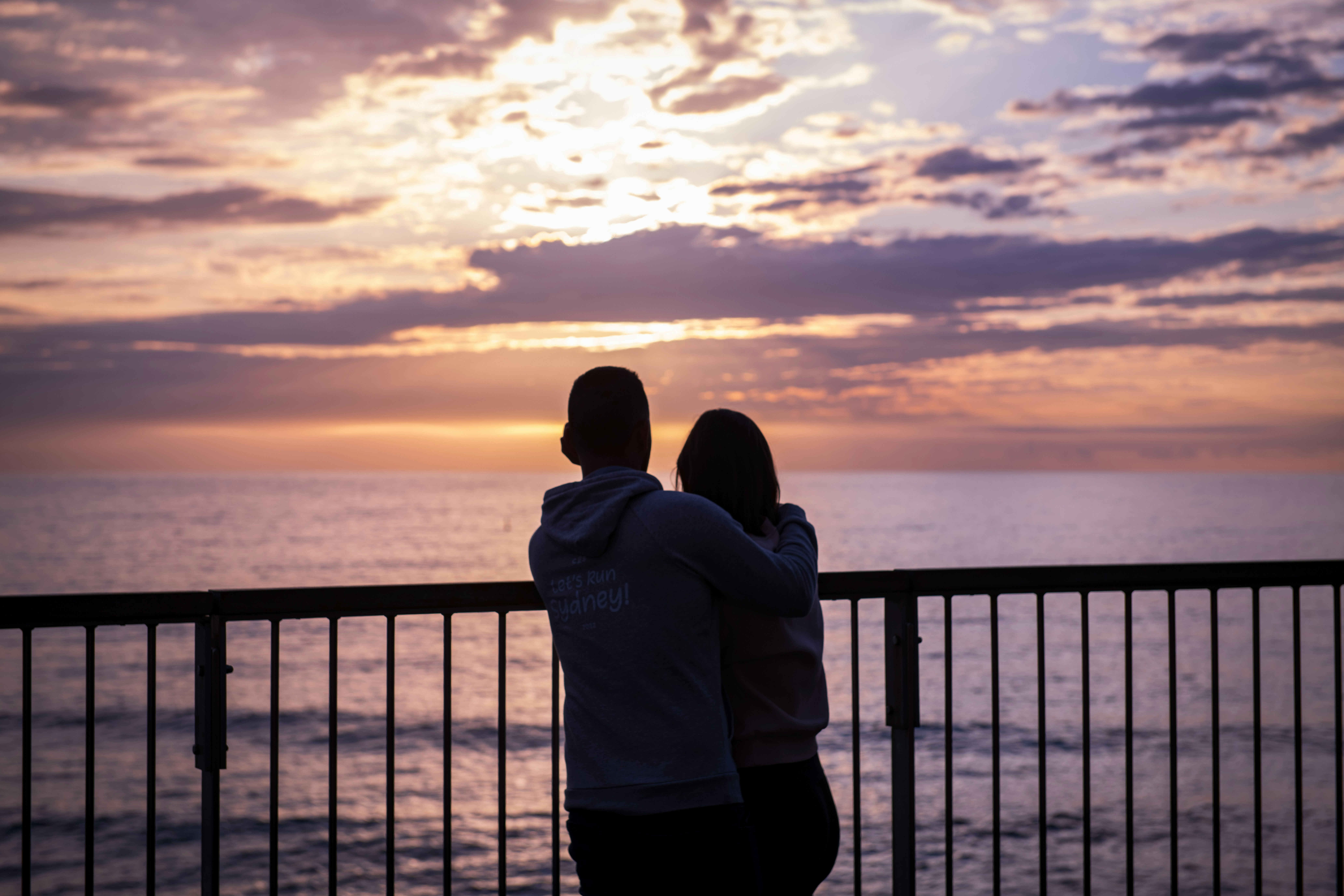 a couple of people that are looking at the water