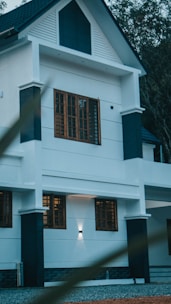 a large white house with a black roof