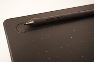 a pen is sitting on top of a tablet