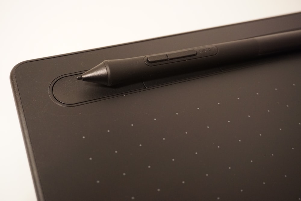 a pen is sitting on top of a tablet