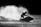 Dynamic shot of a rider smoothly gliding over water with the vortex upgrade kit visible, set against a dark, moody sky.