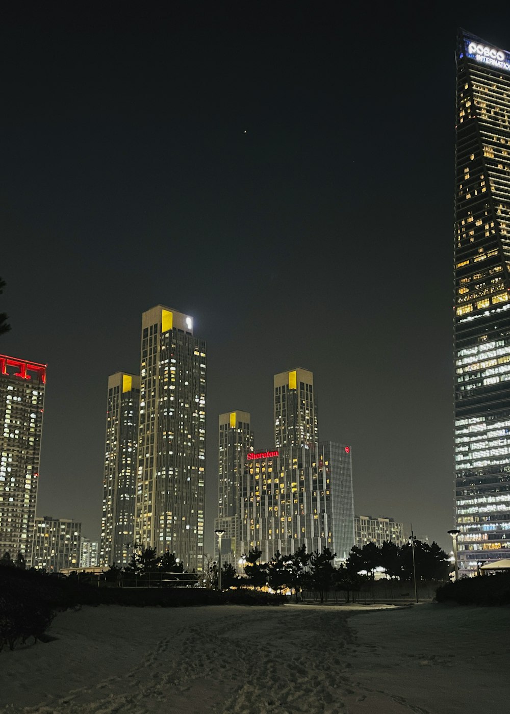 a city skyline at night with skyscrapers lit up