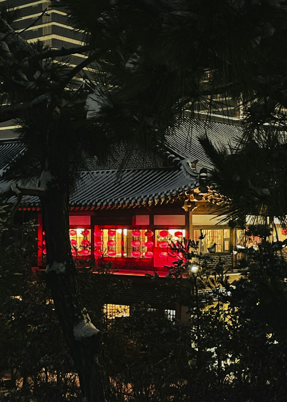 a building lit up at night with red lights