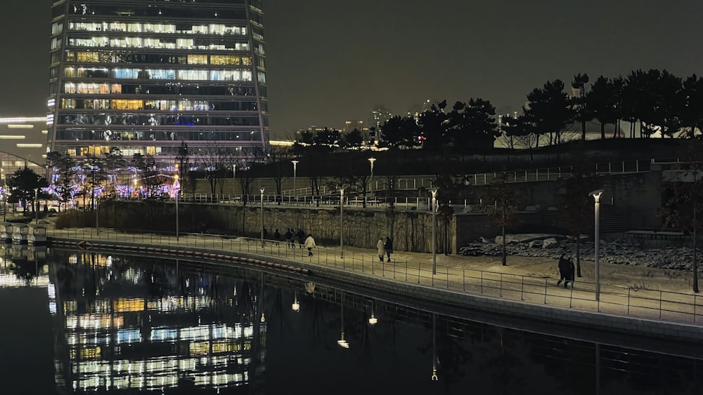 a tall building next to a body of water