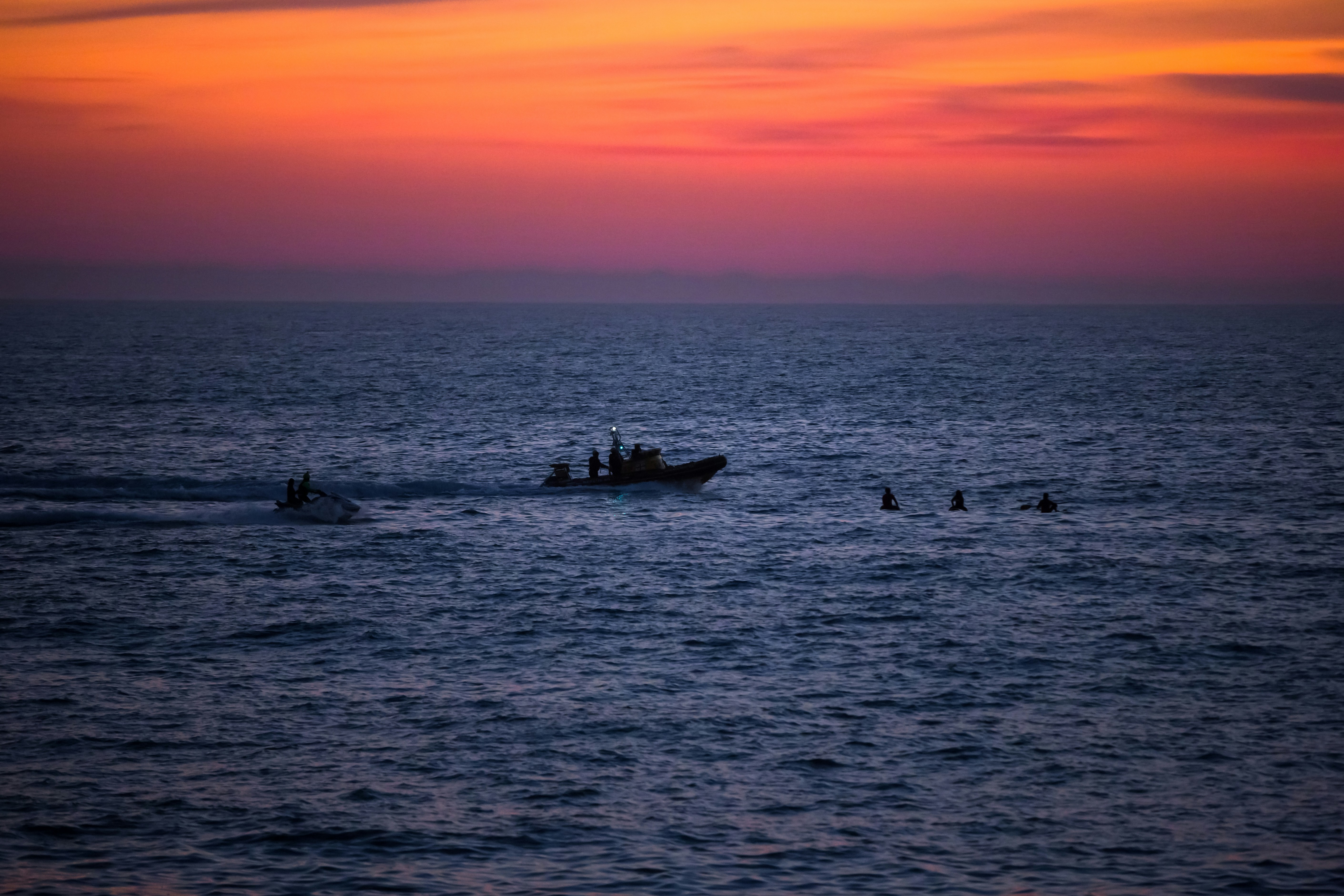 a small boat in the middle of a large body of water
