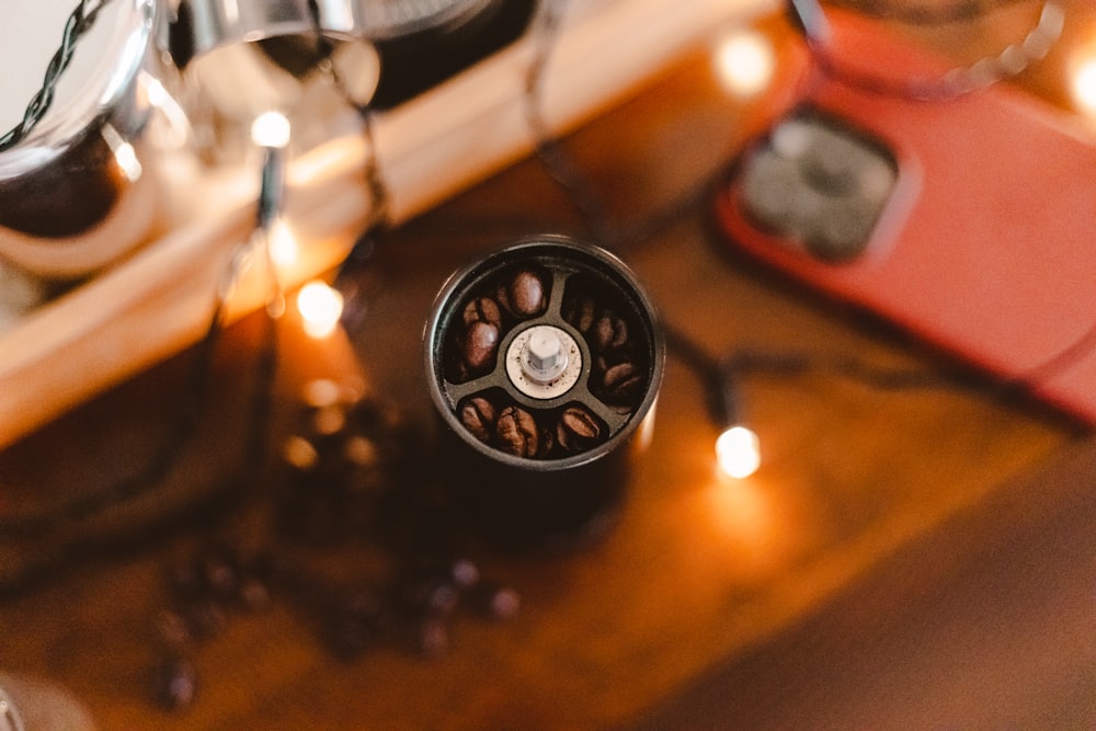 a coffee grinder sitting on top of a wooden table