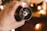 Close-up of a hand holding a steaming cup of coffee next to a stylish Velora coffee grinder.